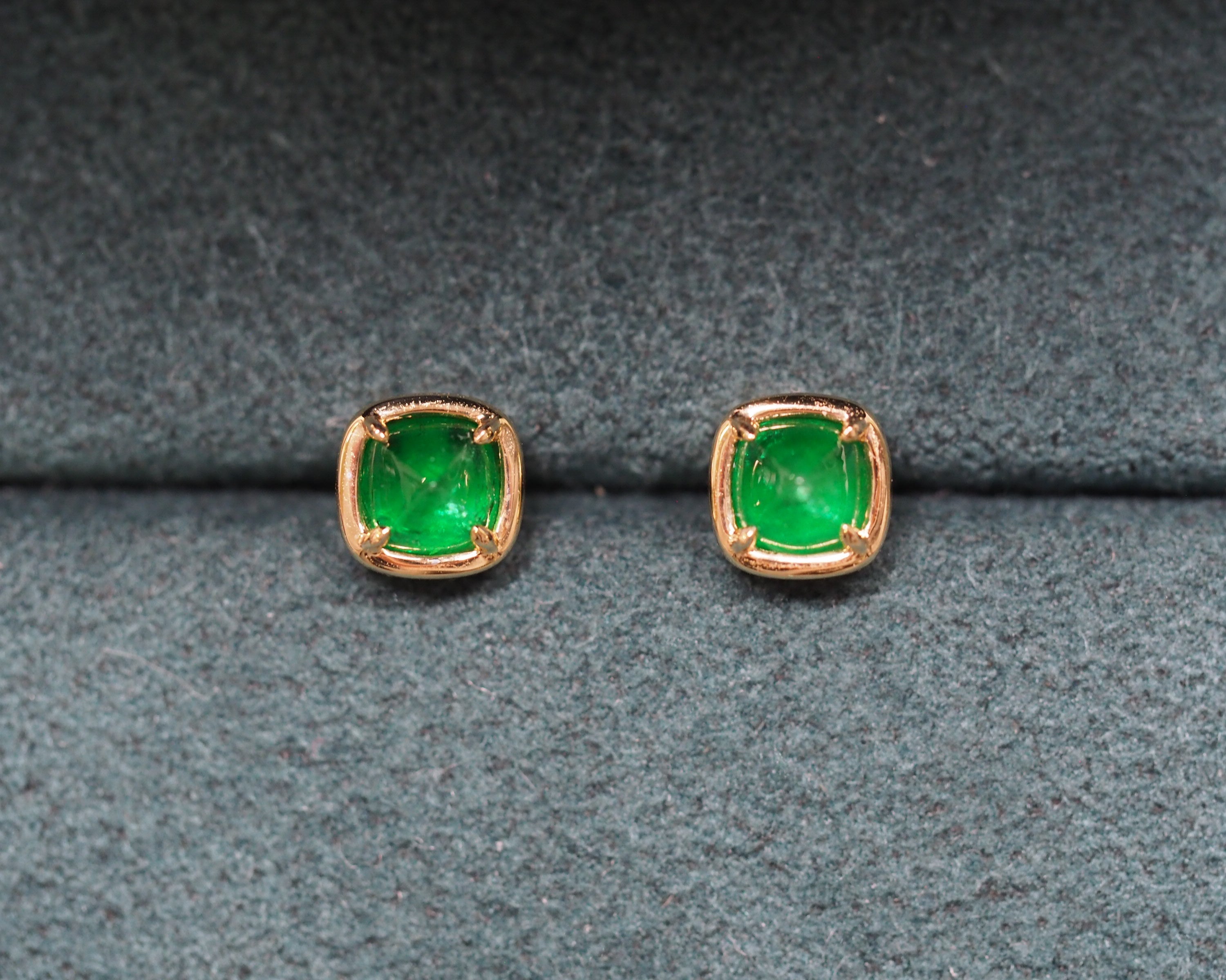 Elizabeth Emerald Studs on a green background