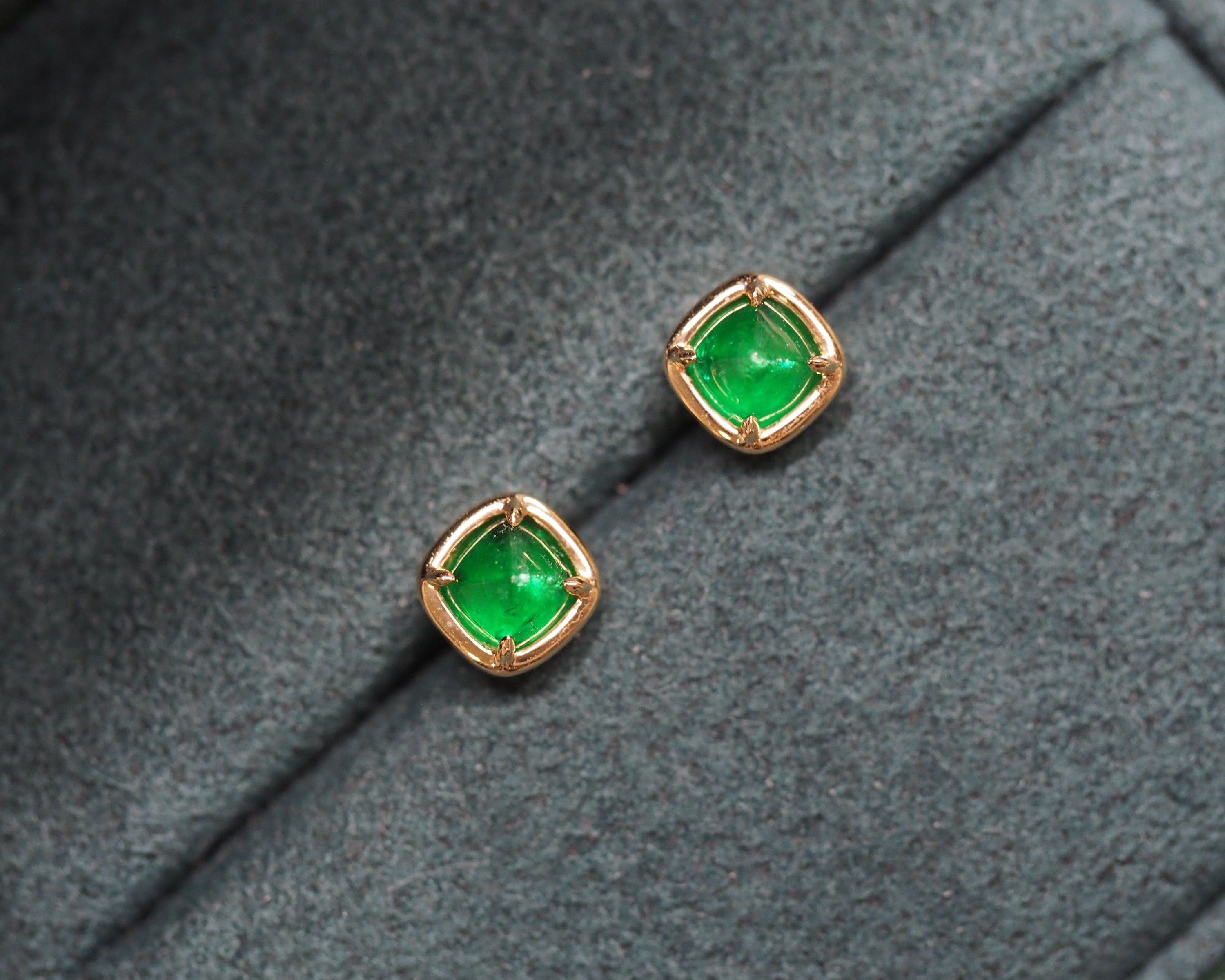Elizabeth Emerald Studs on a green background