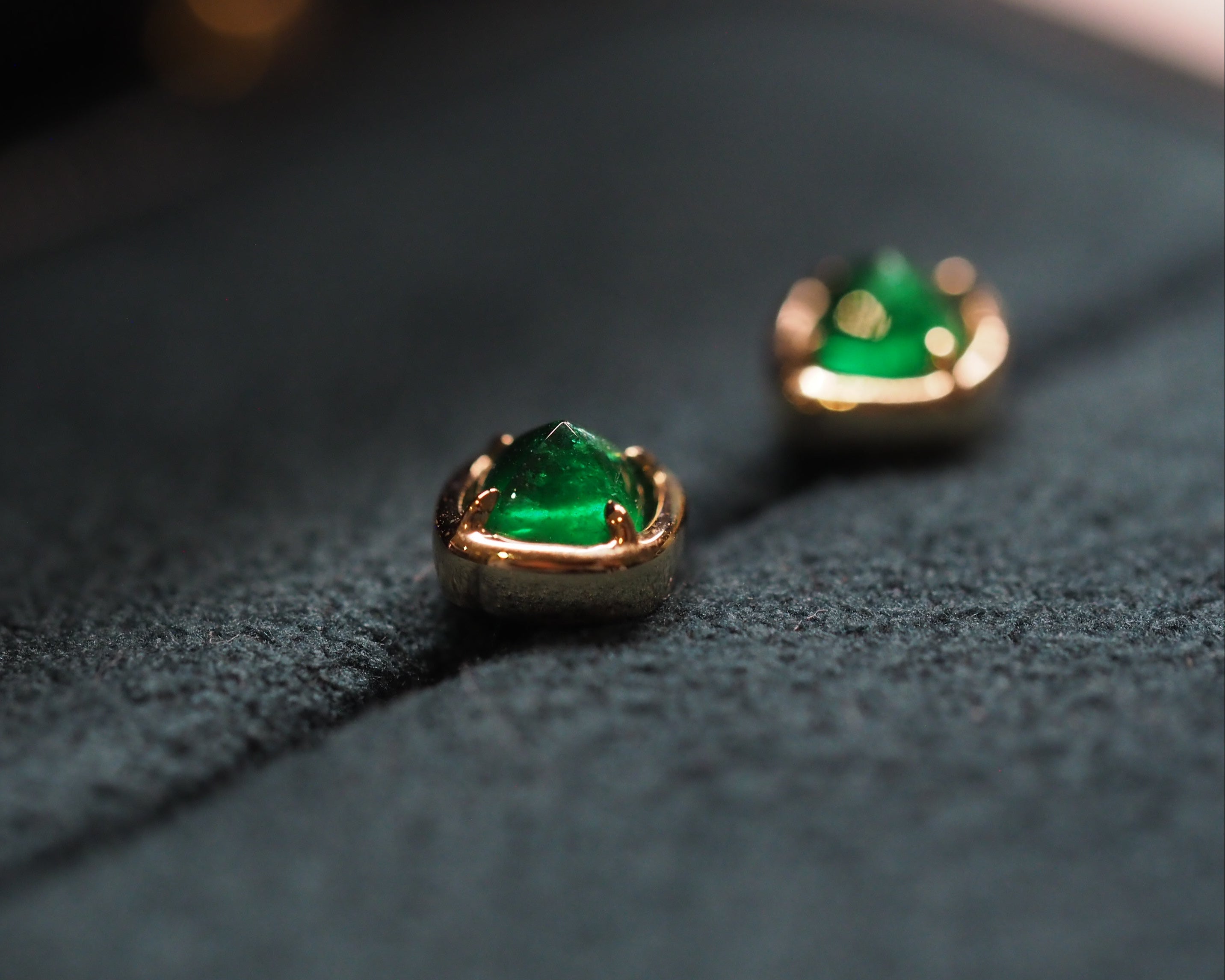 Elizabeth emerald studs resting on a jewelry box